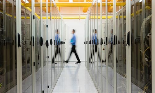 People walking through a modern office hallway